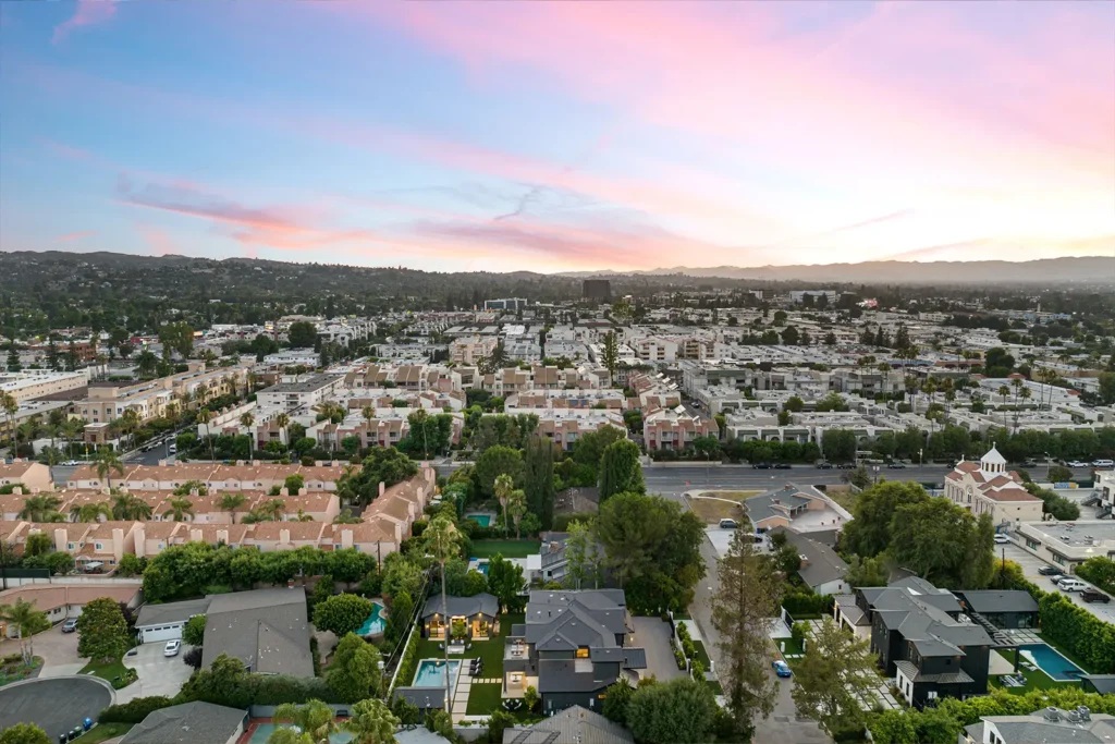 An aerial view of a residential housing district at sunset