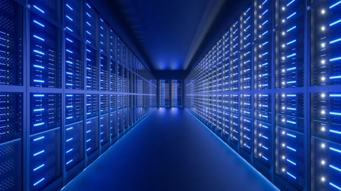 A long corridor, filled with data server computers on either side of the central walkway