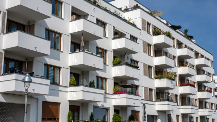 A condominium building with multiple extended balconies.