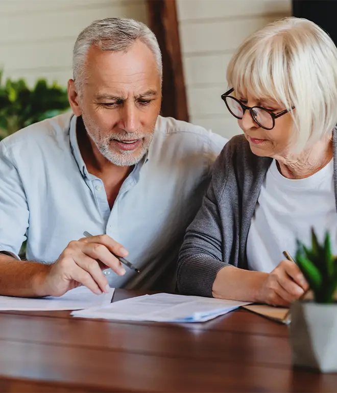 A married couple reviewing paperwork.
