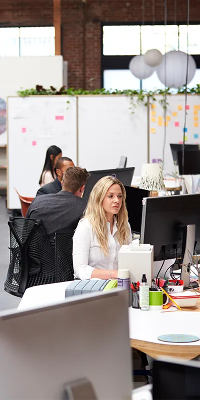 Several office workers in an open office plan