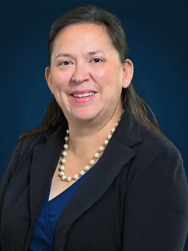 A headshot of attorney Tabitha Atwell in front of a blue background