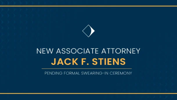 A decorative blue graphic with gold trim, reading "New Associate Attorney: Jack F. Stiens, pending formal swearing-in ceremony."